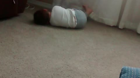 baby rolling on floor