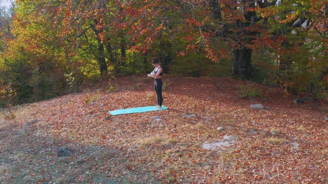 Young woman practicing yoga in the prairie