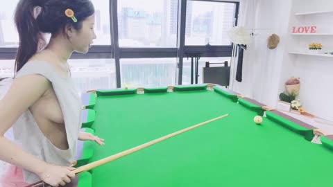 Sexy asia girl wearing green Low-cut vest playing billiard