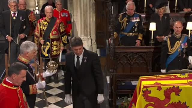 The Imperial State Crown, the Orb and the Sceptre are removed from the coffin