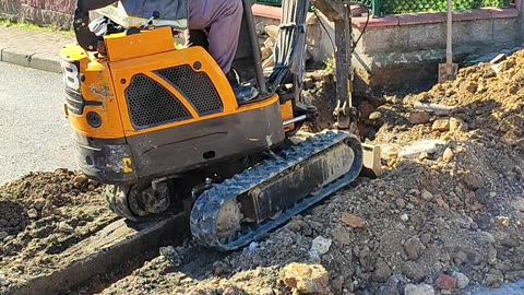 small bulldozer digging a water channel