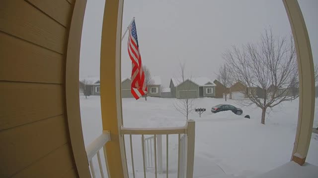 Front door security camera, woman walks down drive way and slips on snow