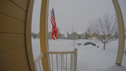Front door security camera, woman walks down drive way and slips on snow