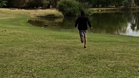 A man walks along the shore