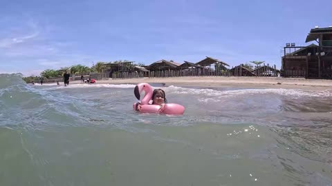 Cheeky Mastering the Philippine Waves on Her Pink Flamingo Floaty