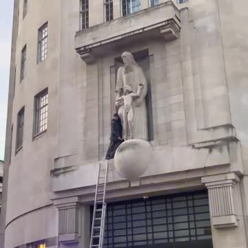 London - Someone climbed onto the BBC building & smashed up the Eric Gill pedo statue