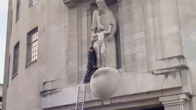 London - Someone climbed onto the BBC building & smashed up the Eric Gill pedo statue