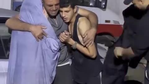 Palestinian teenagers weep alongside their father