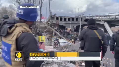 Ukraine destroys bridge of Bucha, residents evacuate by foot along shelled road_