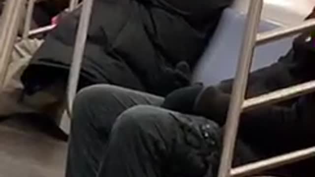 Guy talks to himself on subway train