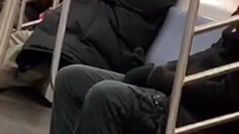 Guy talks to himself on subway train