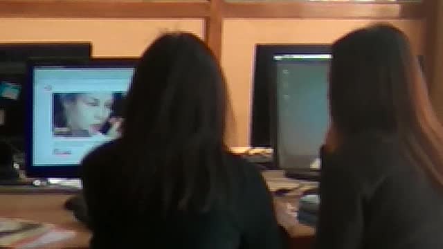 Girl watching makeup tutorial during class hour.