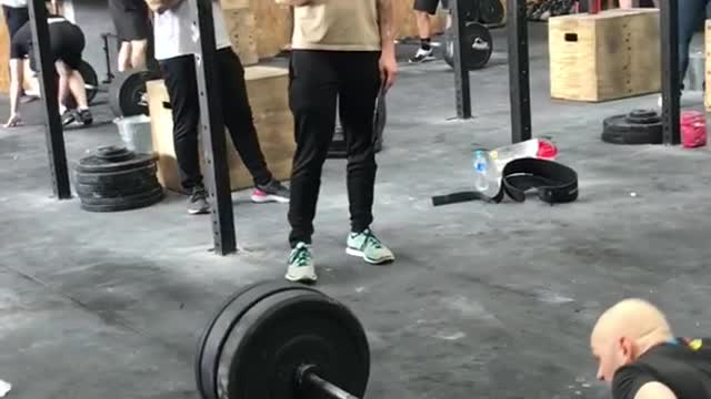 Two guys workout jumping over weight bar lift fail push up