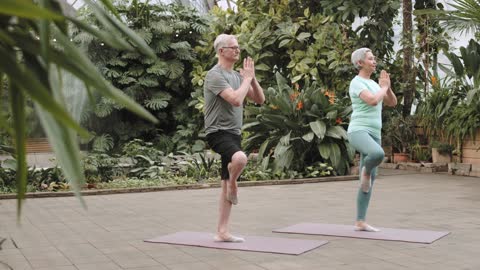 Couple Practicing Yoga Togethre