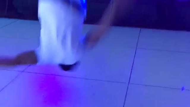 Music white shirt guy front flips on dance floor california