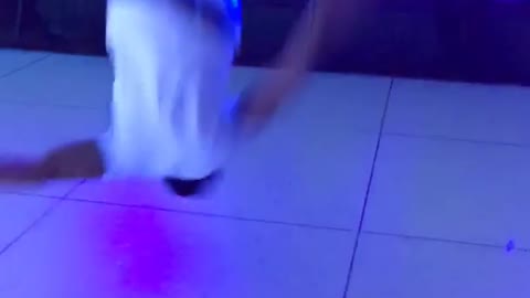 Music white shirt guy front flips on dance floor california