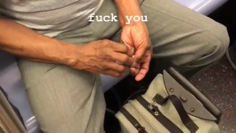 Man in green files nails on subway train