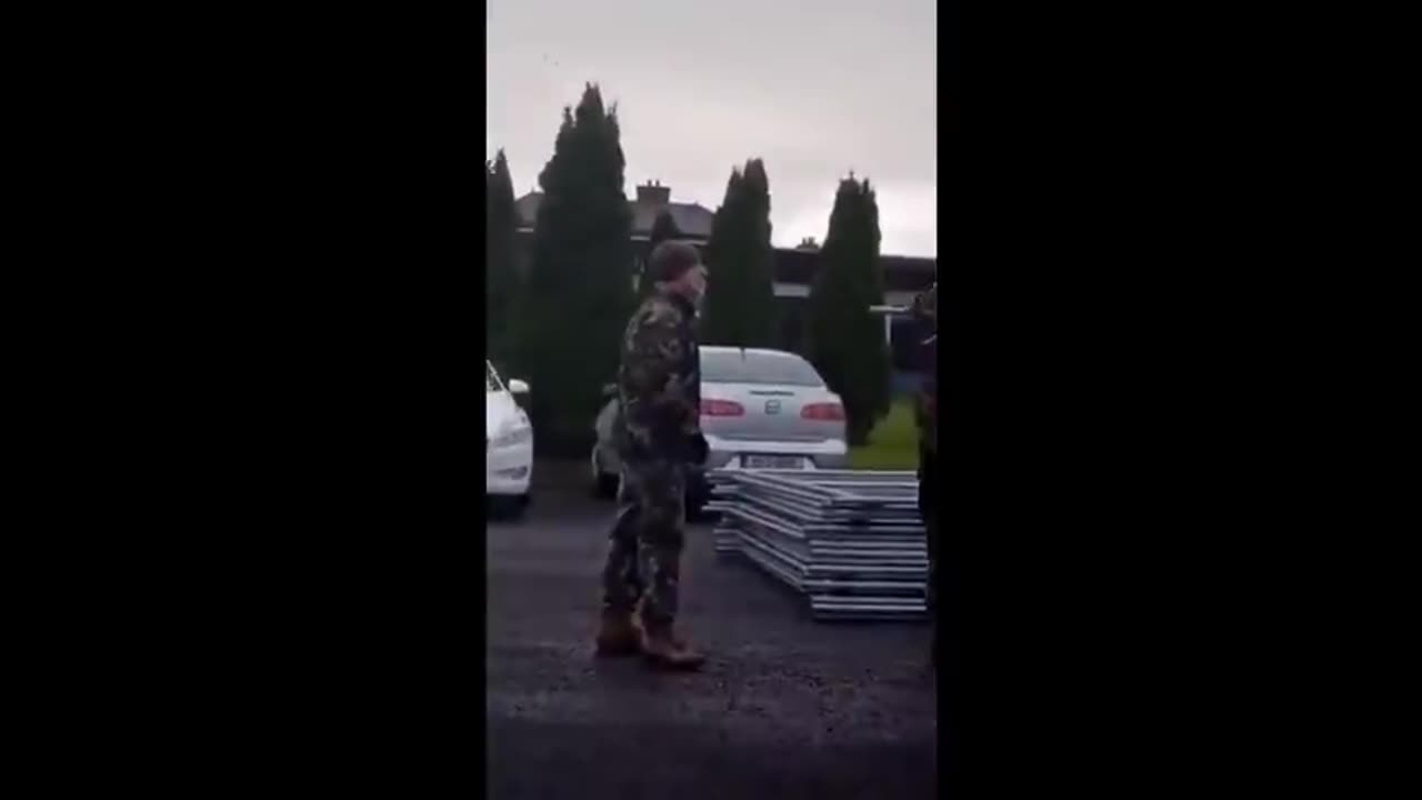 Irish woman confronts soldiers, who are under orders to help set up migrant camps