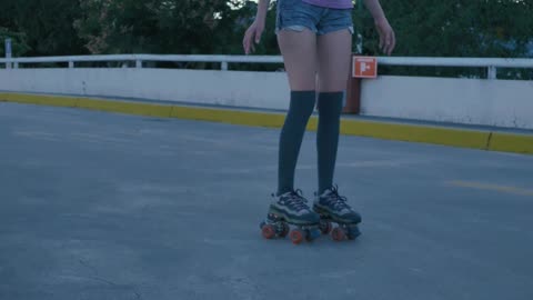 Young urban woman skating slowly during sunset