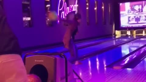 Long jacket woman tries bowling fall down replay