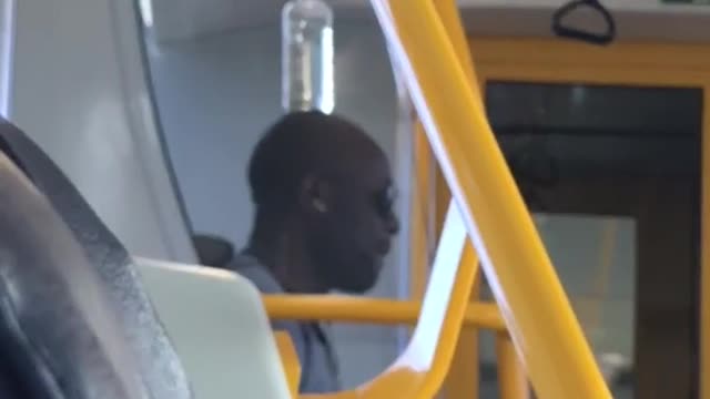 A man balances a bottle of water on head