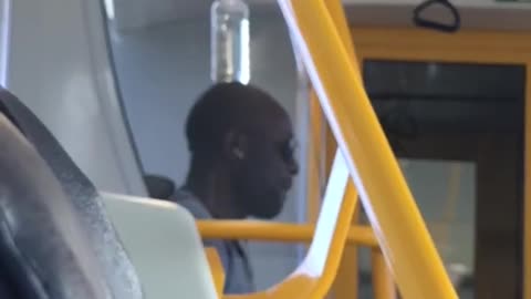 A man balances a bottle of water on head