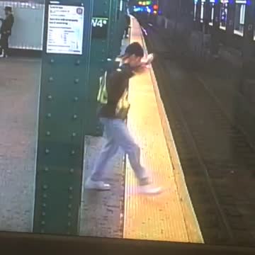 Man in brown vest dancing in subway platform