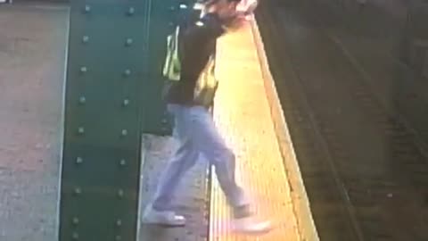 Man in brown vest dancing in subway platform