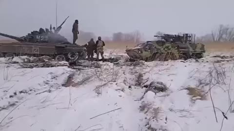 Russian T-72B3 is trying to pull out a Ukrainian BTR-4 stuck and abandoned by the crew