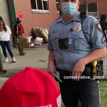 💥💥 VOTER INTIMIDATION_ Masked police are threatening voters with arrest for wearing red MAGA hats