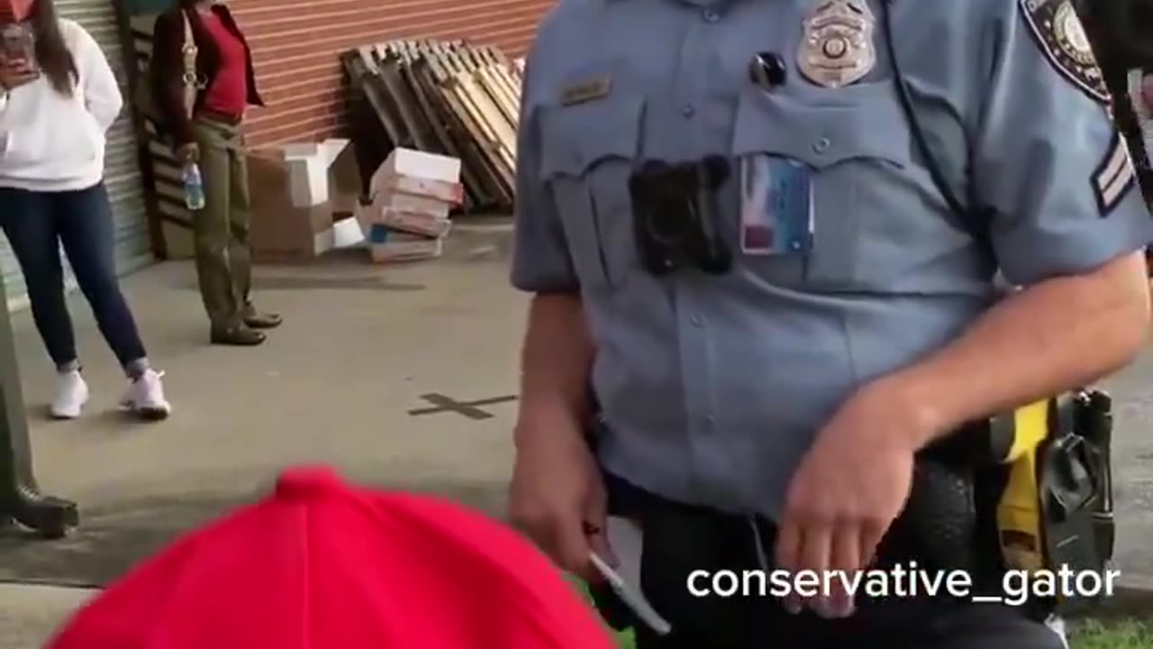 💥💥 VOTER INTIMIDATION_ Masked police are threatening voters with arrest for wearing red MAGA hats