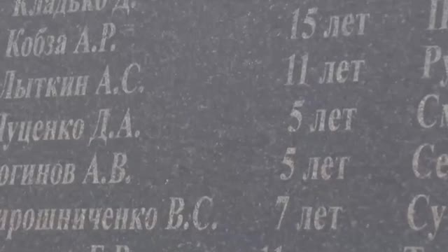 Ukraine POWs are led to the memorial to the children of Donbas..