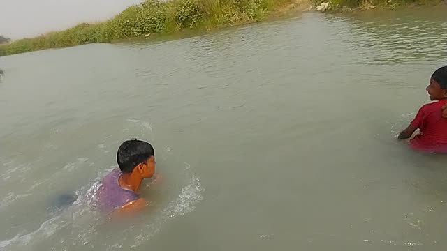 Little boy swimming in river