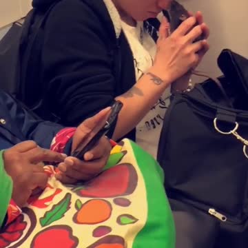 Girl on subway holding rat in her hand