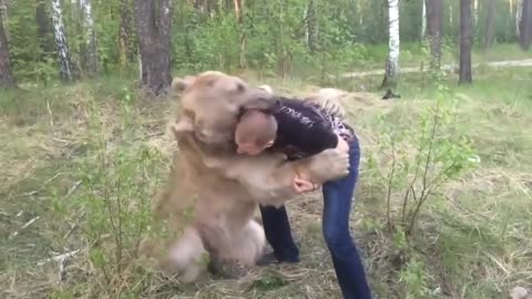 Russian guy plays with bear