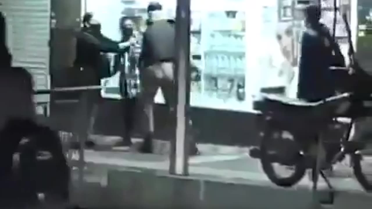 Iran A soldier sees a woman with uncovered hair in the street