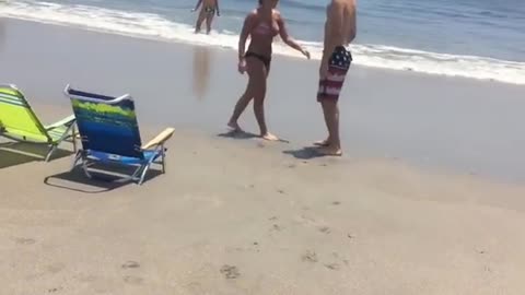 Nsfw guy throws beer at friend on beach and he shotguns it