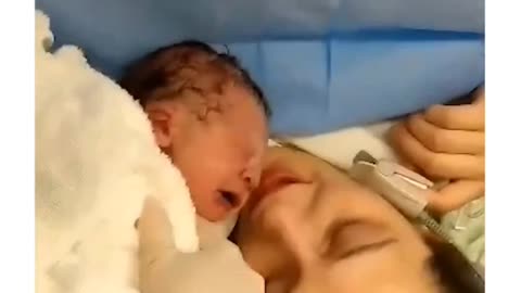 New born baby reacting to mom's kiss....