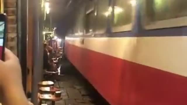 A train track that runs through the middle of the street in Hanoi, the capital of Vietnam.