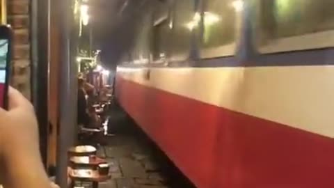 A train track that runs through the middle of the street in Hanoi, the capital of Vietnam.