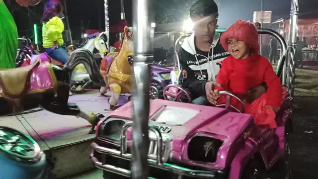 Cute baby with toy car in a local Mela (Fair).