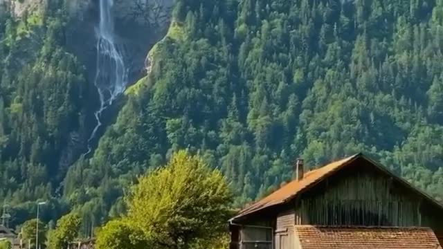 Green hills, villages, and an alpine waterfall.