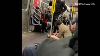 Subway train with guy slumped over sleeping, woman on the floor, guy trips and falls