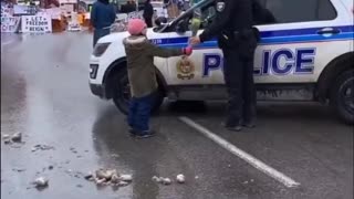 Precious: Little Girl Offers Canadian Agent of the State Flowers At Trucker Protest