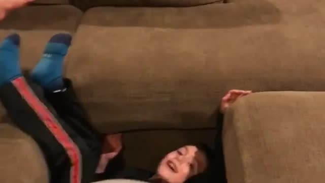 Kid jumps off couch onto exercise ball and falls down