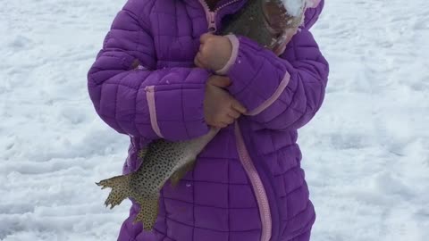 Daughter's First Fish Through the Ice