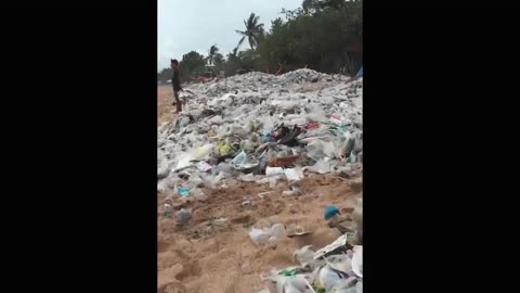 Beautiful beach in Bali is completely covered with plastic and trash washed up from the ocean