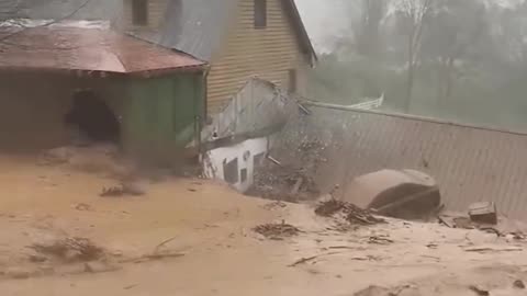 Wall of water and mud rushes down hillside