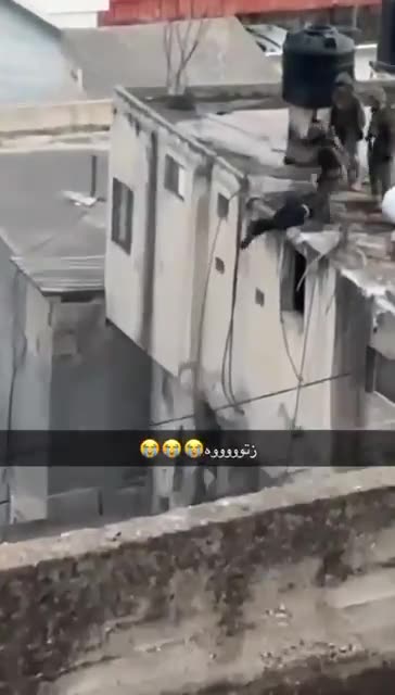 Witness camera ZOOMS IN on Israeli Soldiers kicking an injured man off the roof