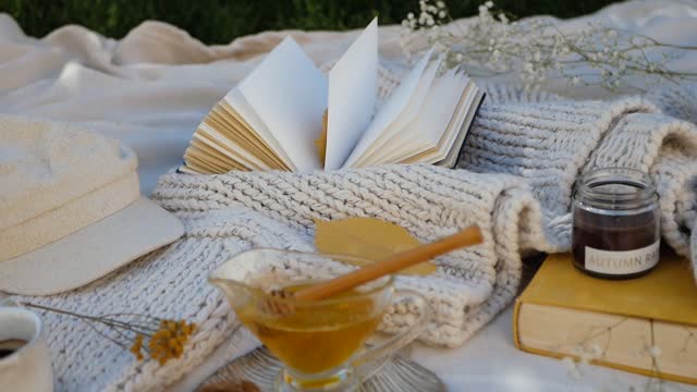 Flat lay Arrangement of Books, Sweaters and Candles